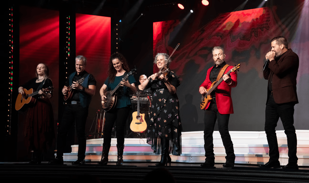 The Duttons family performing on stage with multiple instruments at the Dutton Family Theater in Branson