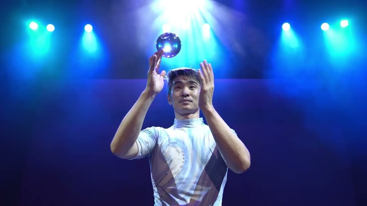 Acrobat juggling a glowing ball at the Shanghai Circus in Branson