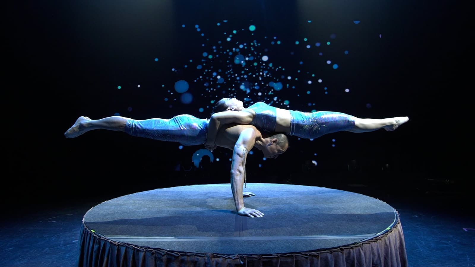 Two Amazing Acrobats of Shanghai performers balancing in a one-hand stand on stage in Branson