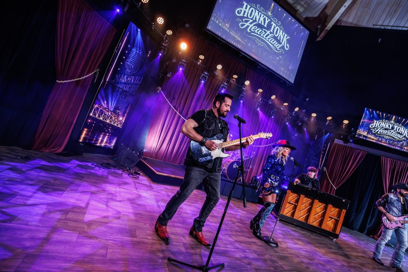 Honky Tonk Heartland performers under the stage lights in Branson