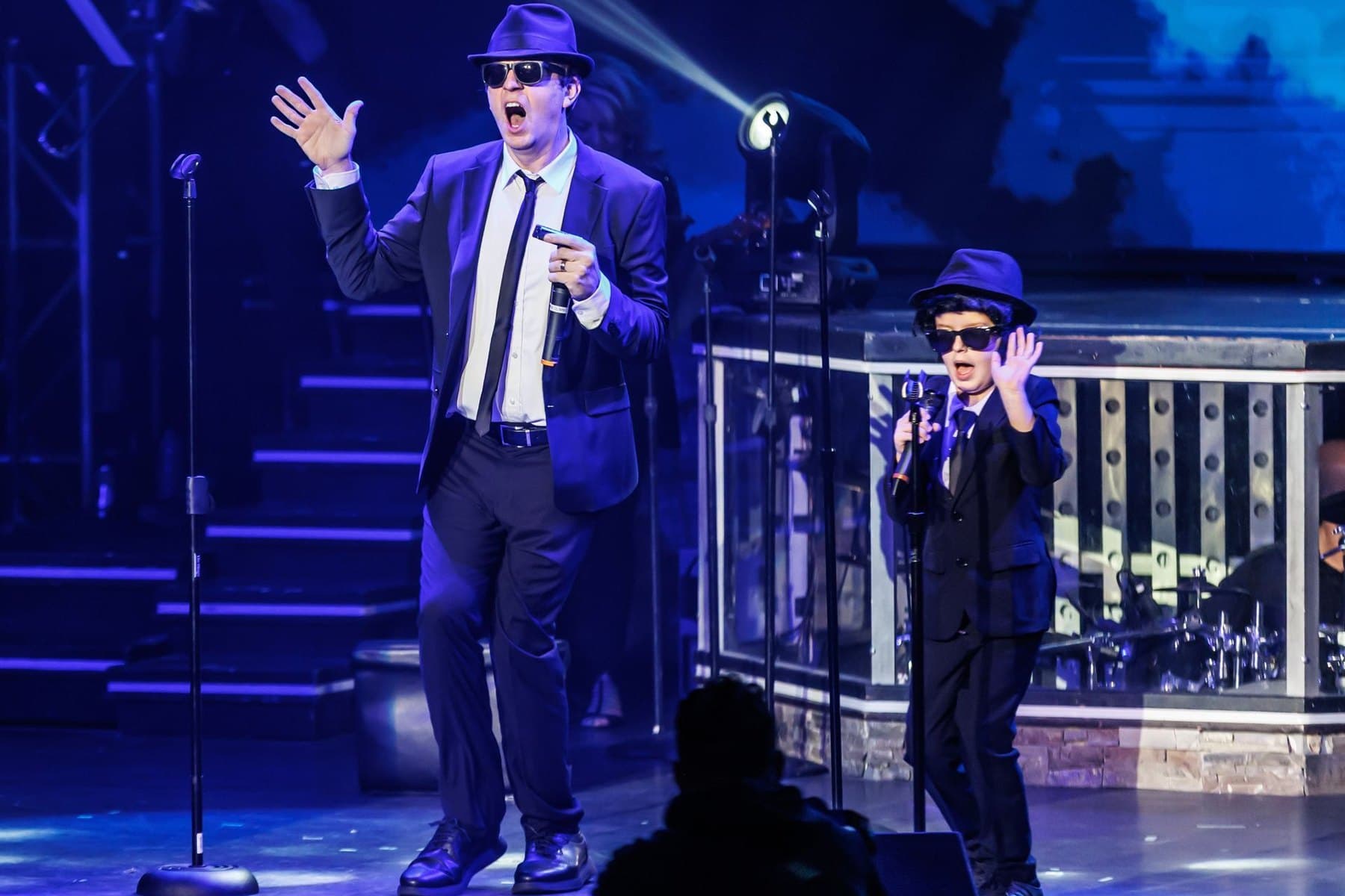 Matt Gumm and his son performing a Blues Brothers routine on stage in Branson