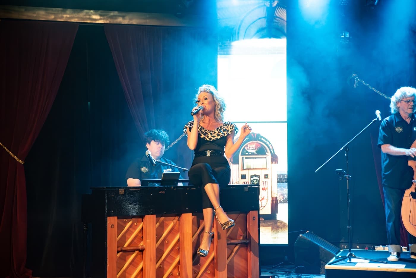 Rock 'n' Roll Sunrise performers under the stage lights in Branson