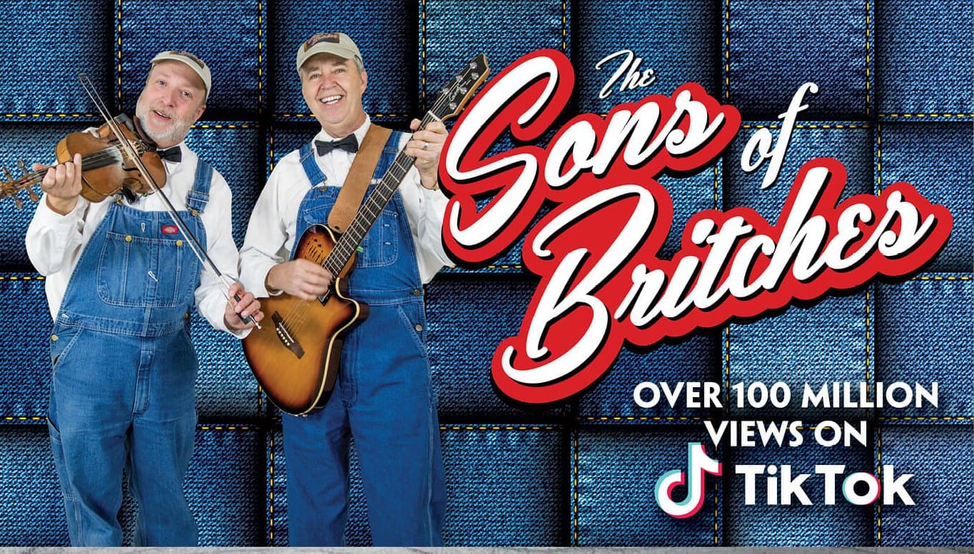 The Sons of Britches in bib overalls with fiddle and guitar in Branson